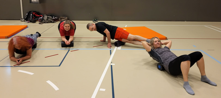 A group of people doing push ups Description automatically generated